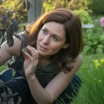 Ogrodniczka przycinająca czarne i suche gałęzie laurowiśni po zimie, sprawdzająca żywe drewno sekatorem